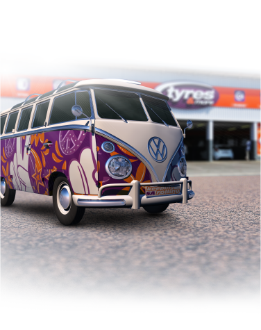 About Us Tyres & More about us illustration; a VW van painted the colours of Tyres & More parked in front of a Tyres & More store.
