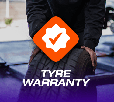 A Tyres & More technician handling a tyre