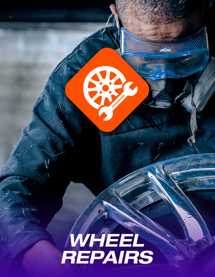 A wheel-technician performing expert alloy wheel repair.