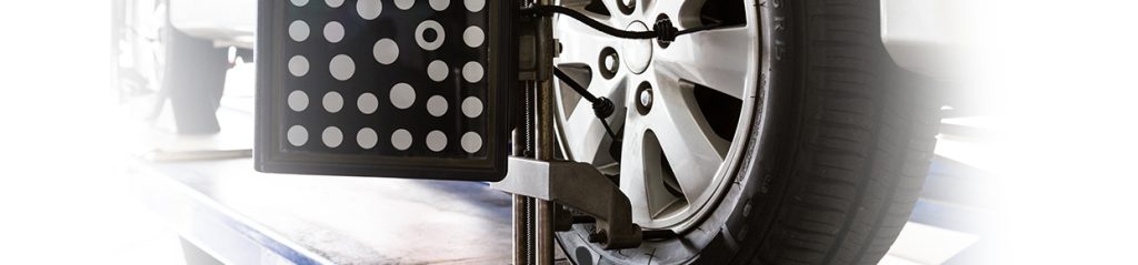 Wheel Alignment A wheel alignment device attached to a car's wheel