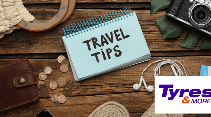 A notebook of travel tips sitting on a desk with other travel items