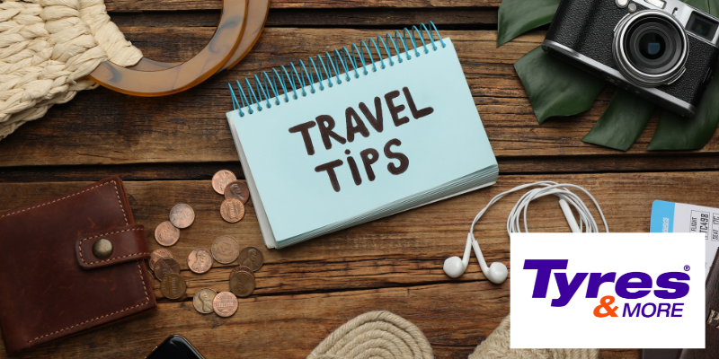 A notebook of travel tips sitting on a desk with other travel items